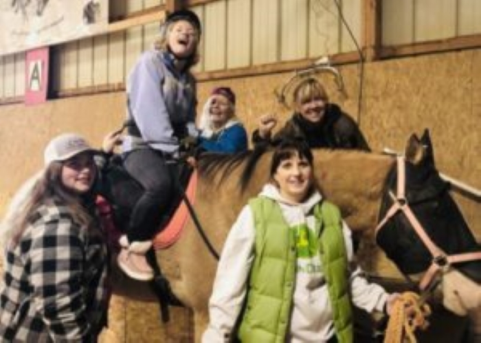 CHAPS volunteers posing with a rider on a horse