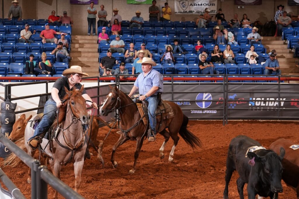 Logan Weldon riding Cat D7 and Mike Weldon riding Docs Highstylin Whiz in Chrome Cash Pro Futurity Championship at 2025 Cinch RSNC World Finals.