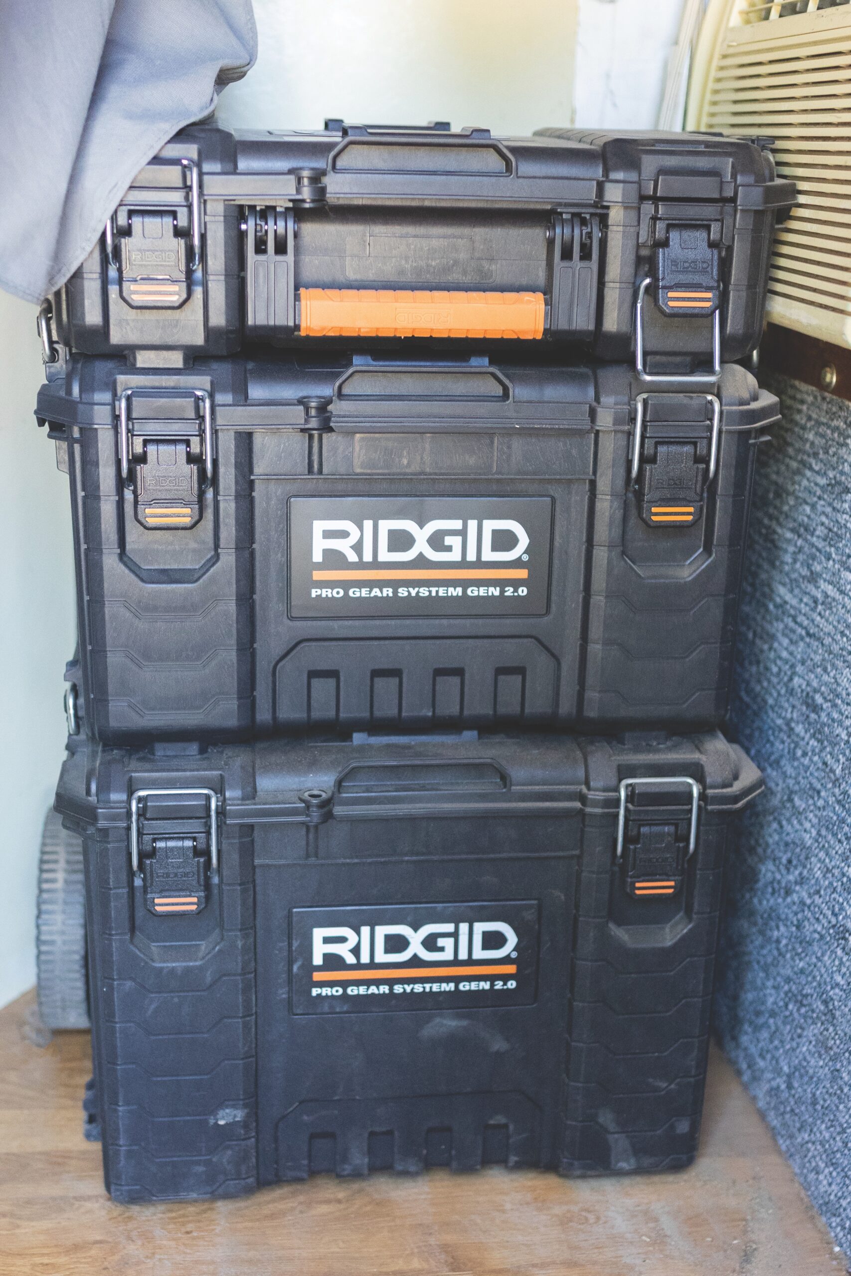 Rigid toolboxes stacked in a horse trailer tack room for organized hauling