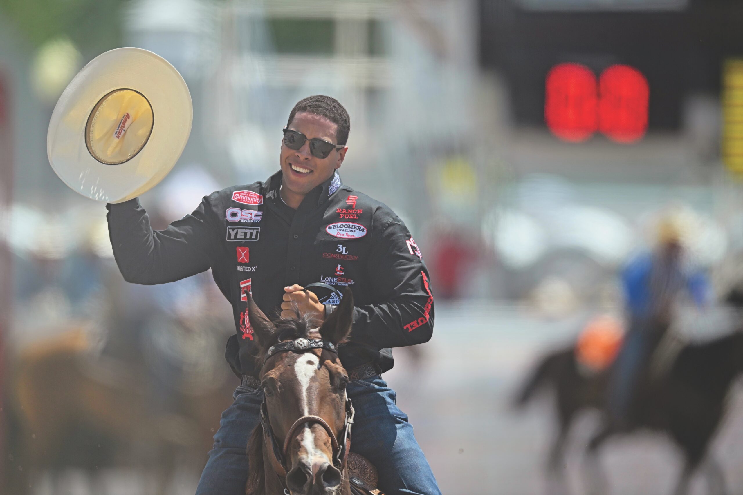 Tie-down roping world champion Shad Mayfield tips his hat from horseback during a rodeo grand entry