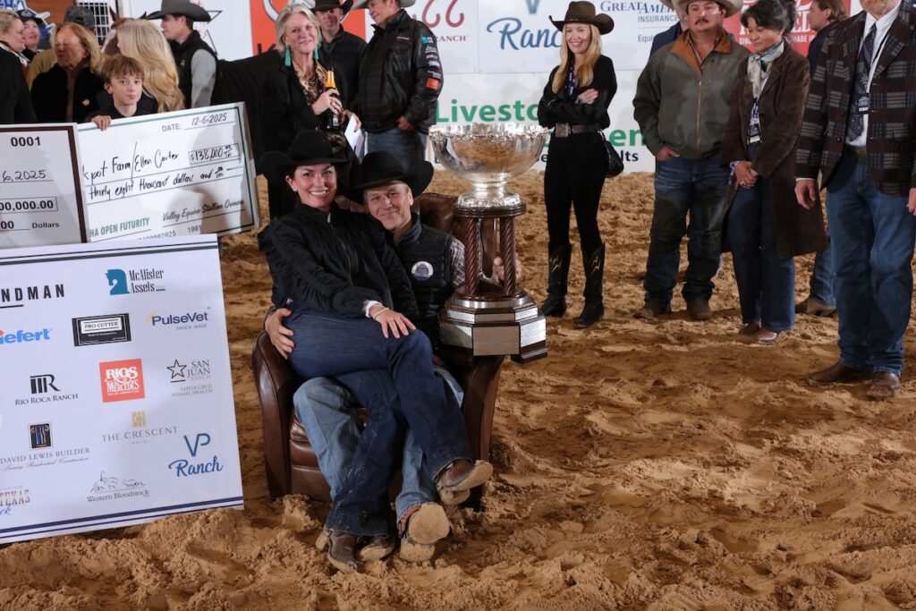 Beau Galyean sits beside the NCHA Futurity championship trophy during the winner’s celebration in Fort Worth.