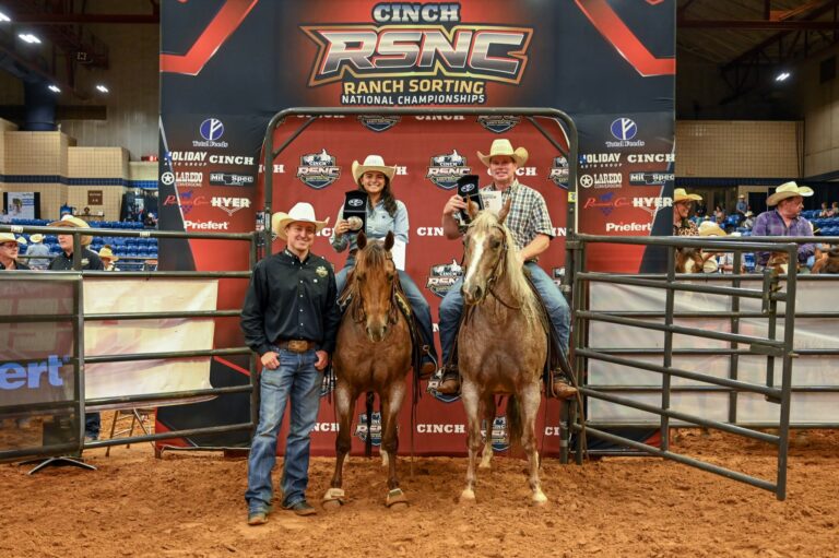 Cali Brookshire and Joel Lesh on horseback holding championship buckles at the 2026 Cinch RSNC World Finals in Fort Worth