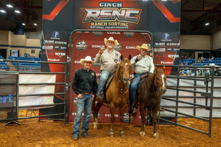 Russell Klostermann and Scott Stresen-Reuter on horseback holding championship buckles at the 2026 Cinch RSNC World Finals in Fort Worth