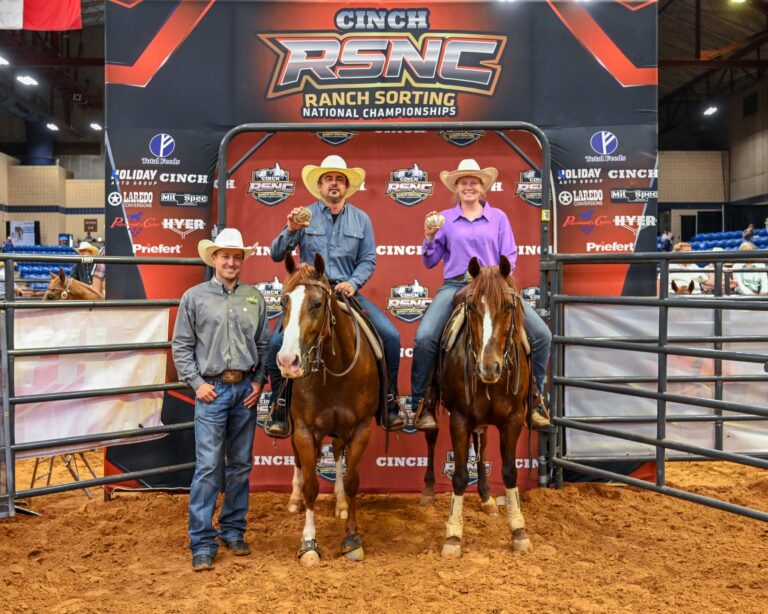 Chris Mangold and Sidney Rasmussen on horseback holding championship buckles at the 2026 Cinch RSNC World Finals #14 Ranch Hand